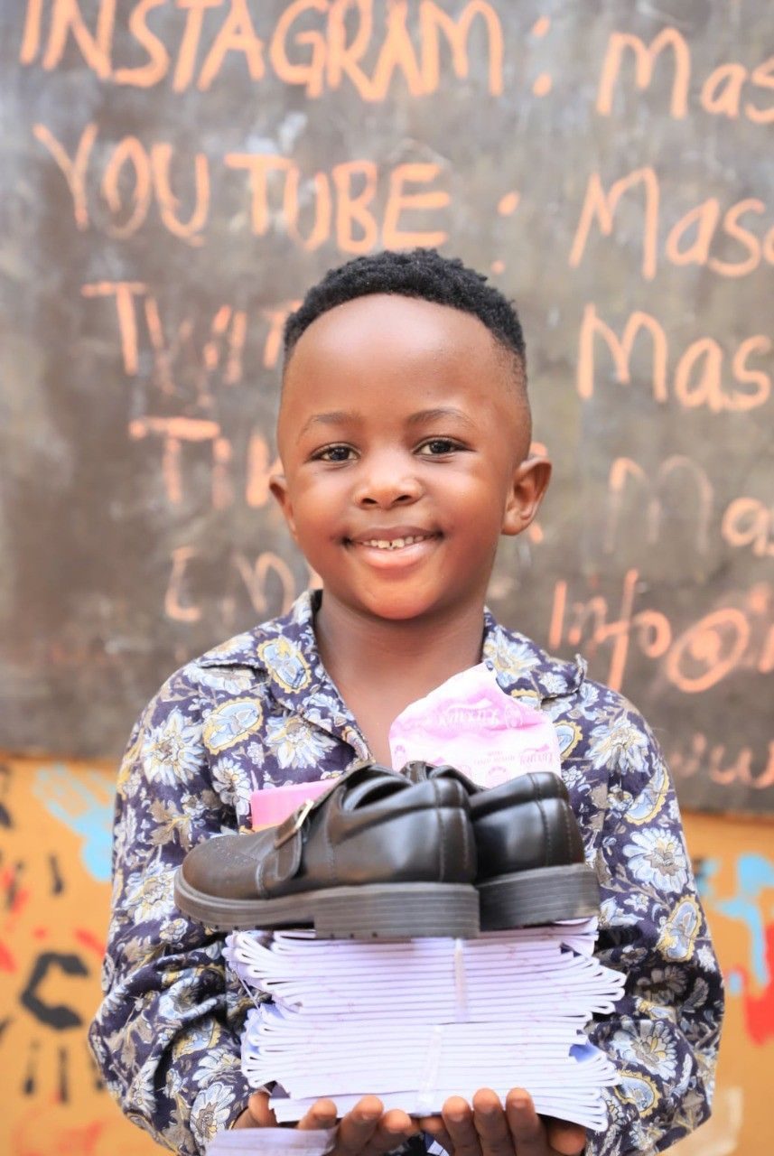 Beneficiary carrying school supplies